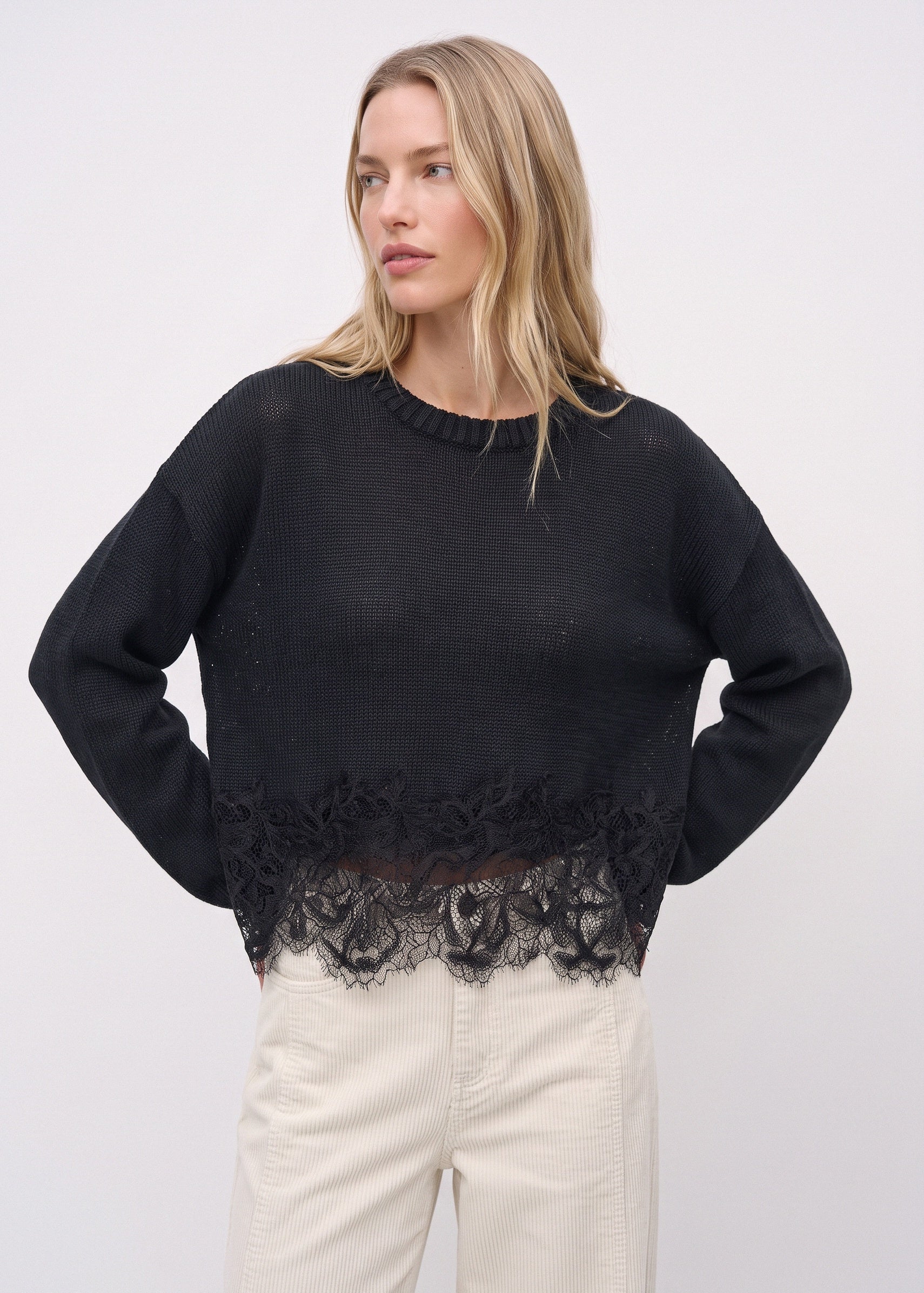 Black linen sweater with tonal floral lace hem, front view