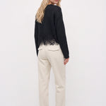 White corduroy pants, back three-quarter view
