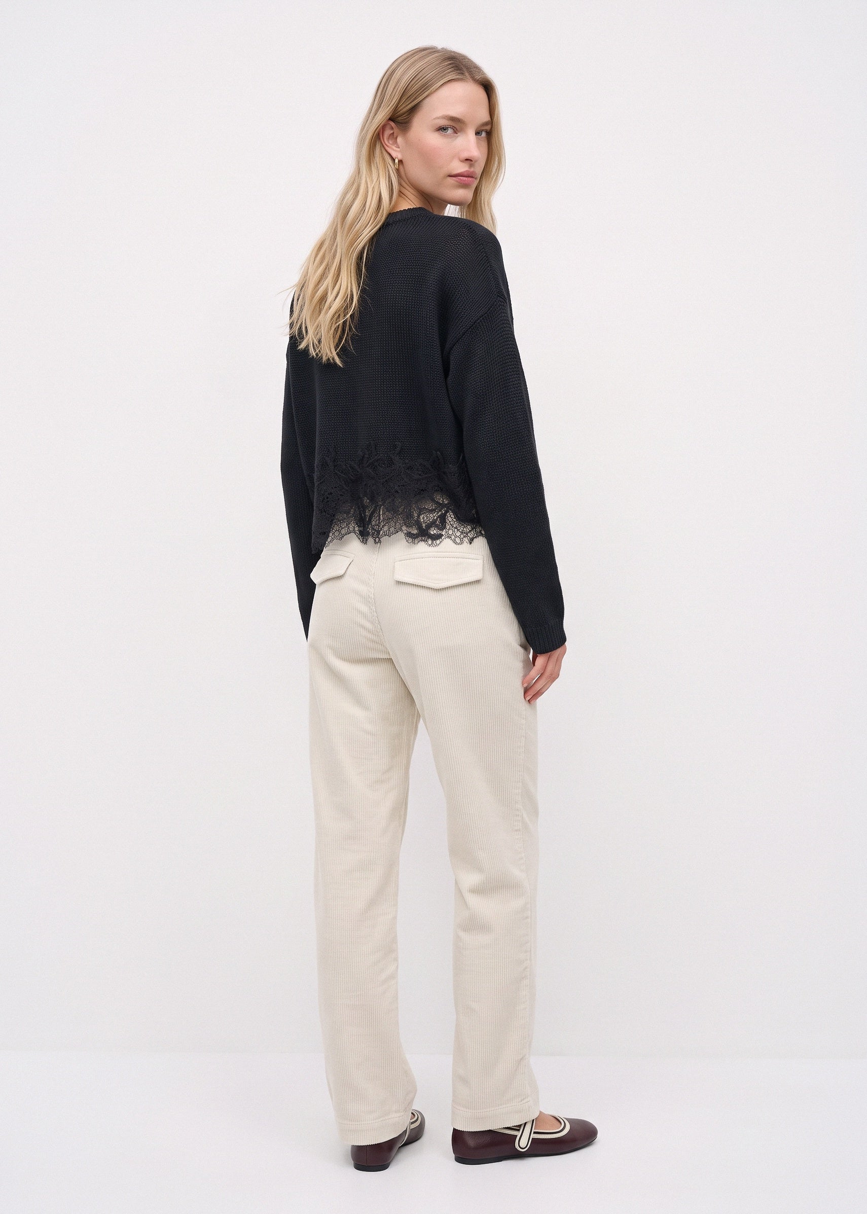 White corduroy pants, back three-quarter view
